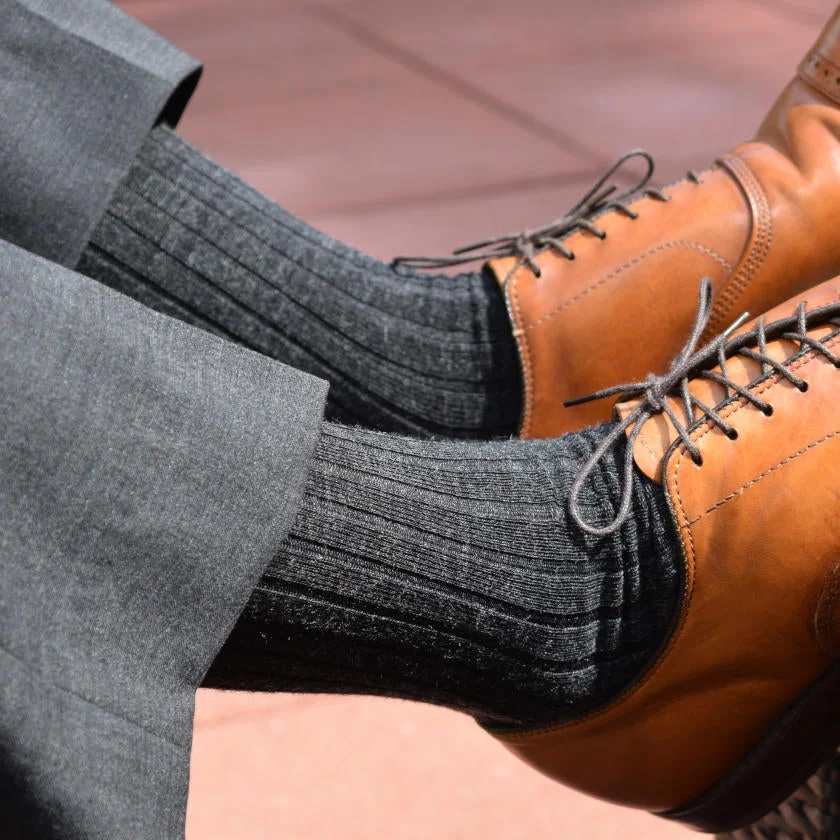 grey dress socks for men paired with grey dress pants and light brown dress shoes